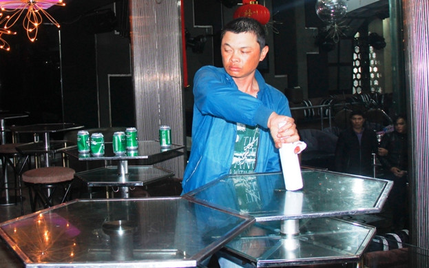 Hoàng Công Thuật diễn tả lại hành động đập chai bia vào đầu người bảo vệ và đâm Huỳnh Quý. Ảnh: Công an Nhân dân