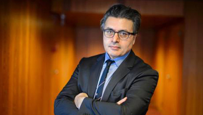 Bác sĩ người Đức Kizilhan tại hội nghị ở Geneva. Ảnh: AFP.