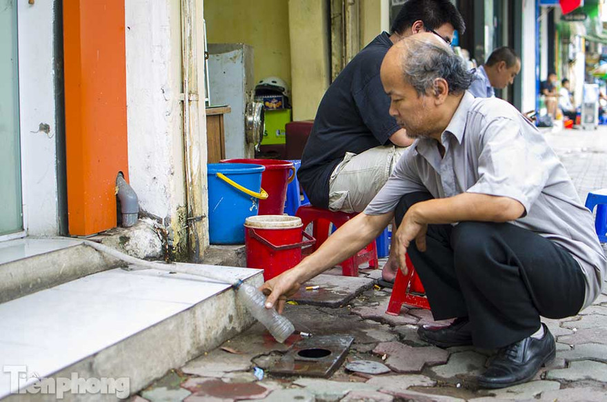 Người dân hứng nước điều hòa để sử dụng.