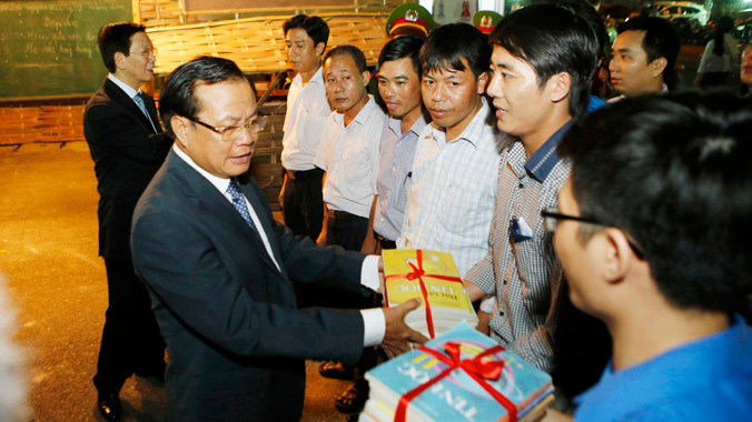  Bí thư thành ủy Hà Nội Phạm Quang Nghị trao tặng sách cho lớp học vùng cao tại Hội sách Hà Nội 2014. Ảnh: Như Ý