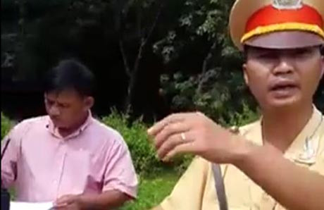 Phạm Minh Trí (nhân viên tiếp thị sữa) đứng ghi biên bản vi phạm giúp Thượng úy Võ Chí Công,