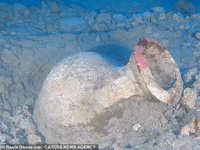 Một trong số những chiếc bình cổ bị bể, trong khi số còn lại vẫn nguyên vẹn và đang được vớt lên. Ảnh: CNA