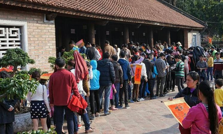 Tiết trời nắng như mùa hè, hàng người xin chữ vẫn kiên nhẫn xếp hàng chờ đến lượt.