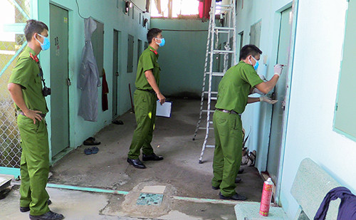 Cảnh sát khám nghiệm phòng trọ của cô gái bị sát hại. Ảnh: C.A.