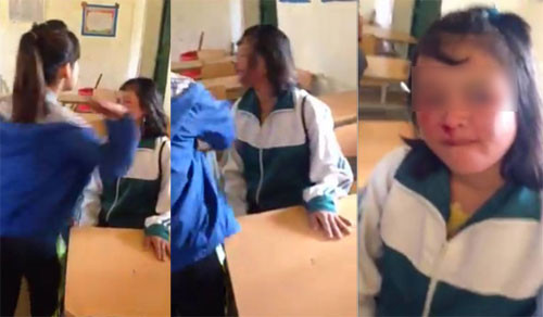 Nữ sinh chảy máu mũi, mặt bị sưng khi bị bạn tát liên tiếp vào mặt. Ảnh cắt từ clip.