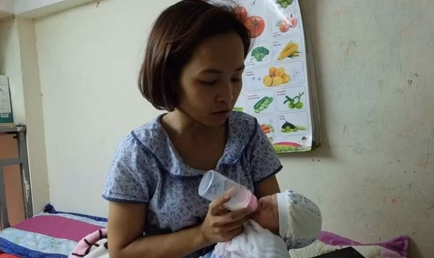 Chị Hòa đang chăm sóc cháu bé.