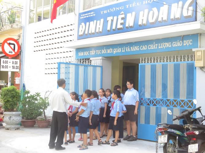 Học sinh xếp hàng chờ giáo viên dẫn đi học.