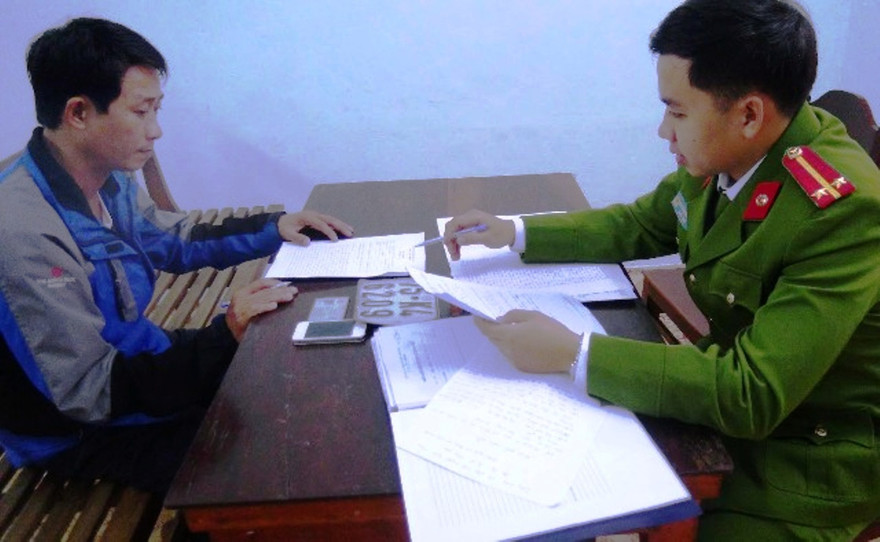 Đối tượng Lê Trường Quân (trái) tại cơ quan công an.