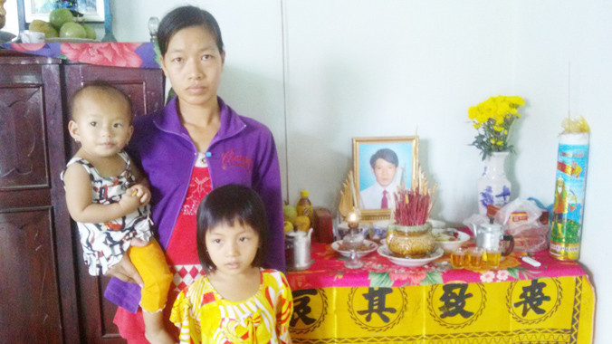 Vợ và con anh Sang trước di ảnh chồng. Ảnh: Hòa Hội.