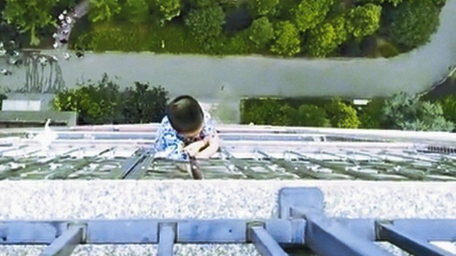 Bé trai trượt chân ngã và treo lơ lửng bên ngoài ban công tầng 19 hơn nửa giờ. Ảnh: dzrbs.com.