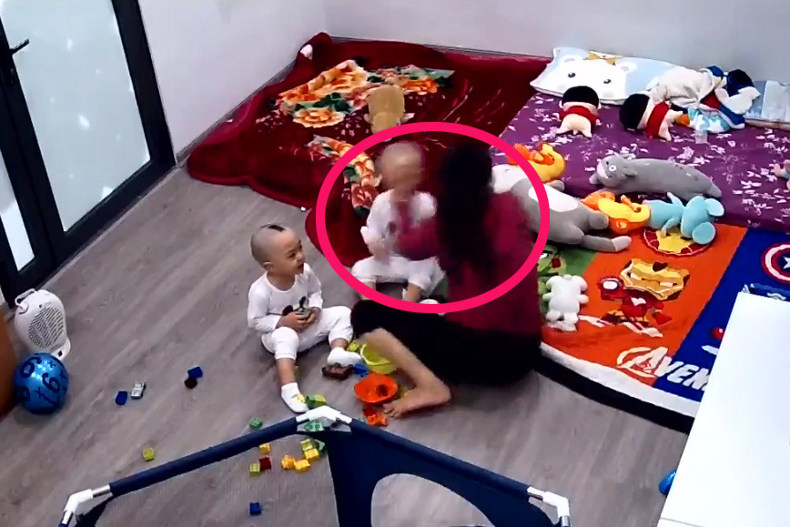 Hình ảnh người giúp việc tát cháu bé ngã xuống giường. Ảnh cắt từ video