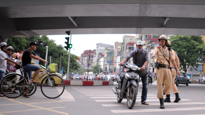 Lực lượng CSGT kiểm tra, nhắc nhở người tham gia vì an toàn tính mạng không nên đội mũ bảo hiểm kém chất lượng. Ảnh: Tuấn Nguyễn