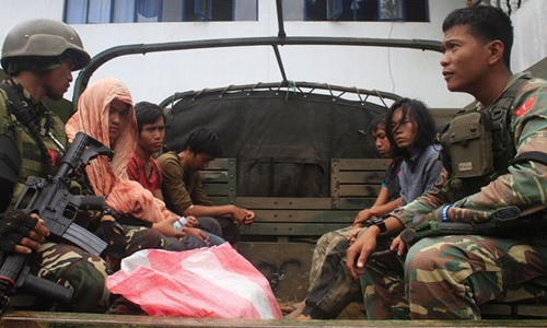 Binh sĩ quân đội Philippines áp giải các thành viên của Maute. Ảnh: AFP.