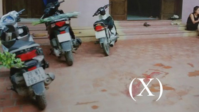 Chất bẩn (X) trong sân nhà ông Đạt. Ảnh: Cơ quan điều tra cung cấp.