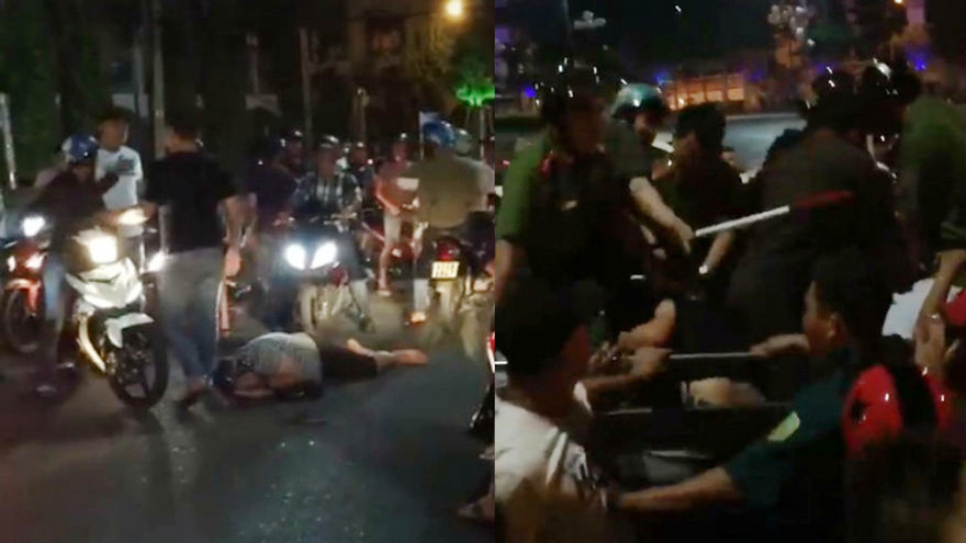 Nam thanh niên bị đánh hội đồng gục tại chỗ vì tuyên bố dùng tiền "ném chết người". Ảnh: Cắt Clip