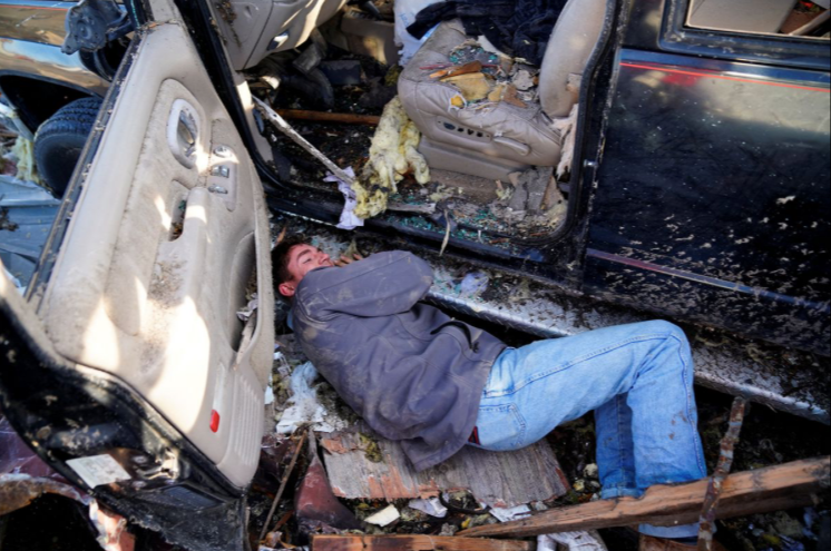 Anh Chris Reed, người dân bang Kentucky, đang cố đưa chiếc ô-tô của mình ra khỏi đống đổ nát do lốc xoáy gây ra. (Ảnh: Reuters) 