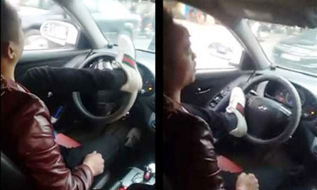 Tài xế lái xe bằng chân chạy qua nhiều tuyến phố ở Hà Nội. Ảnh cắt từ clip