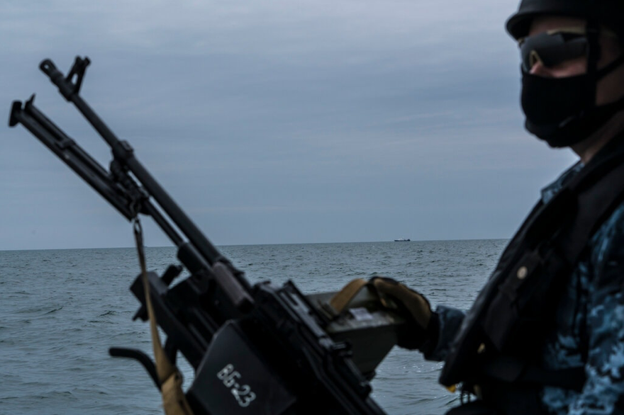 Một lính Nga tuần tra trên biển Azov ngày 19/4, cách đó không xa là một tàu của Nga. (ảnh: NYT) 