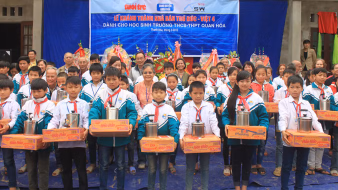 Các em học sinh huyện Quan Hóa (Thanh Hóa) nhận quà của các bác Việt kiều tại lễ khánh thành, bàn giao Nhà bán trú Đức - Việt 4. Ảnh: Hoàng Lam.