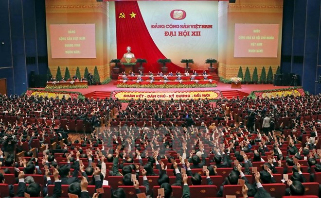 Các đại biểu biểu quyết thông qua Nghị quyết Đại hội XII Đảng Cộng sản Việt Nam. (Nguồn: TTXVN)