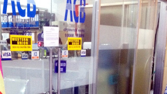 Phòng giao dịch ngân hàng ACB và một số cửa hàng có dấu hiệu trộm đột nhập được cảnh sát phong toả, điều tra hiện trường. Ảnh: Quốc Thắng