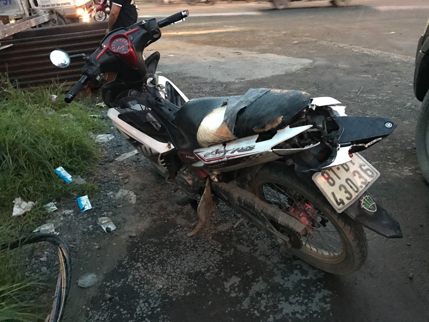 Chiếc xe máy của hai thanh niên bị hư hỏng sau tai nạn.