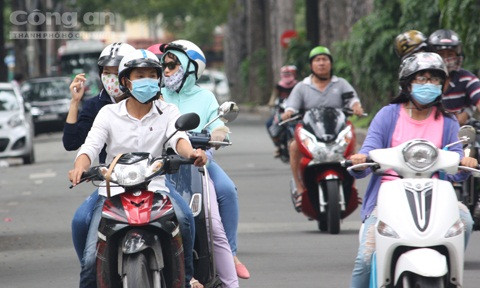 Nắng nóng nên khi ra đường nhiều người che chắn kín mít như “Ninja”. Ảnh: Hoàng Anh.