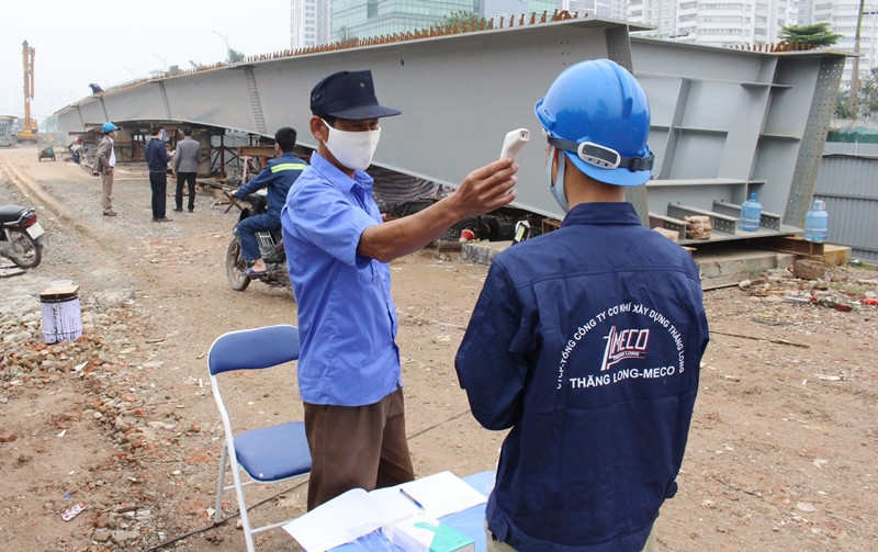Công nhân trước khi vào công trường giao thông Hà Nội được đo thân nhiệt. Ảnh: Trọng Đảng
