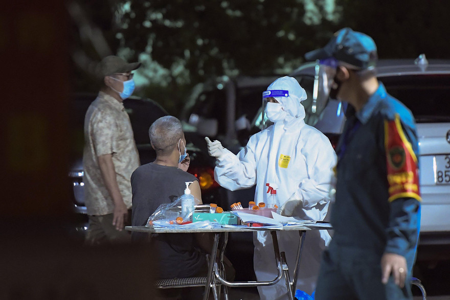 Lấy mẫu xét nghiệm cho các trường hợp liên quan chùm ca bệnh ở phố Lê Trọng Tấn. Ảnh: Hoàng Mạnh Thắng