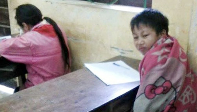 Học sinh THCS tại huyện Bắc Mê, Hà Giang quấn chăn tránh rét. Ảnh: Bích Hoạt. 
