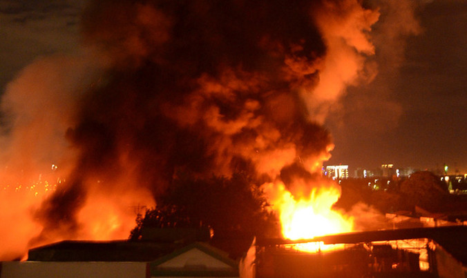 Lửa bốc lên cuồn cuộn, bao trùm kho hàng. Ảnh: Dân Trí.
