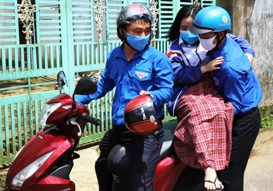 dìu thí sinh bị thương lên xe, chở đến điểm thi tốt nghiệp THPT