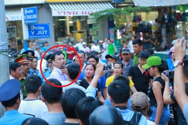 Ông Vũ Văn Hưng (vòng tròn đỏ), Phó chủ tịch UBND TP Buôn Ma Thuột trong vòng vây của hàng chục tiểu thương