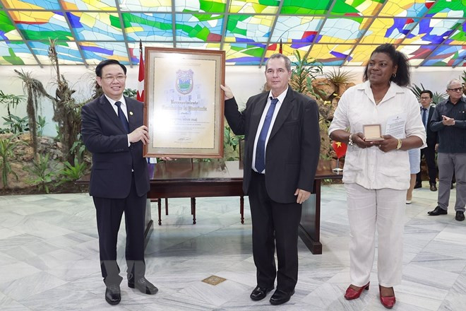 Lãnh đạo thành phố Santiago de Cuba trao kỷ niệm chương tặng Chủ tịch Quốc hội Vương Đình Huệ, vị khách danh dự của địa phương. (Ảnh: Doãn Tấn/TTXVN)