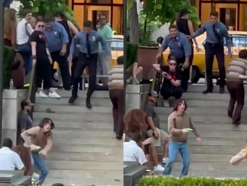 Cảnh Holland bị hai người đàn ông mặc đồng phục bảo vệ truy đuổi. Ảnh: Daily Mail.