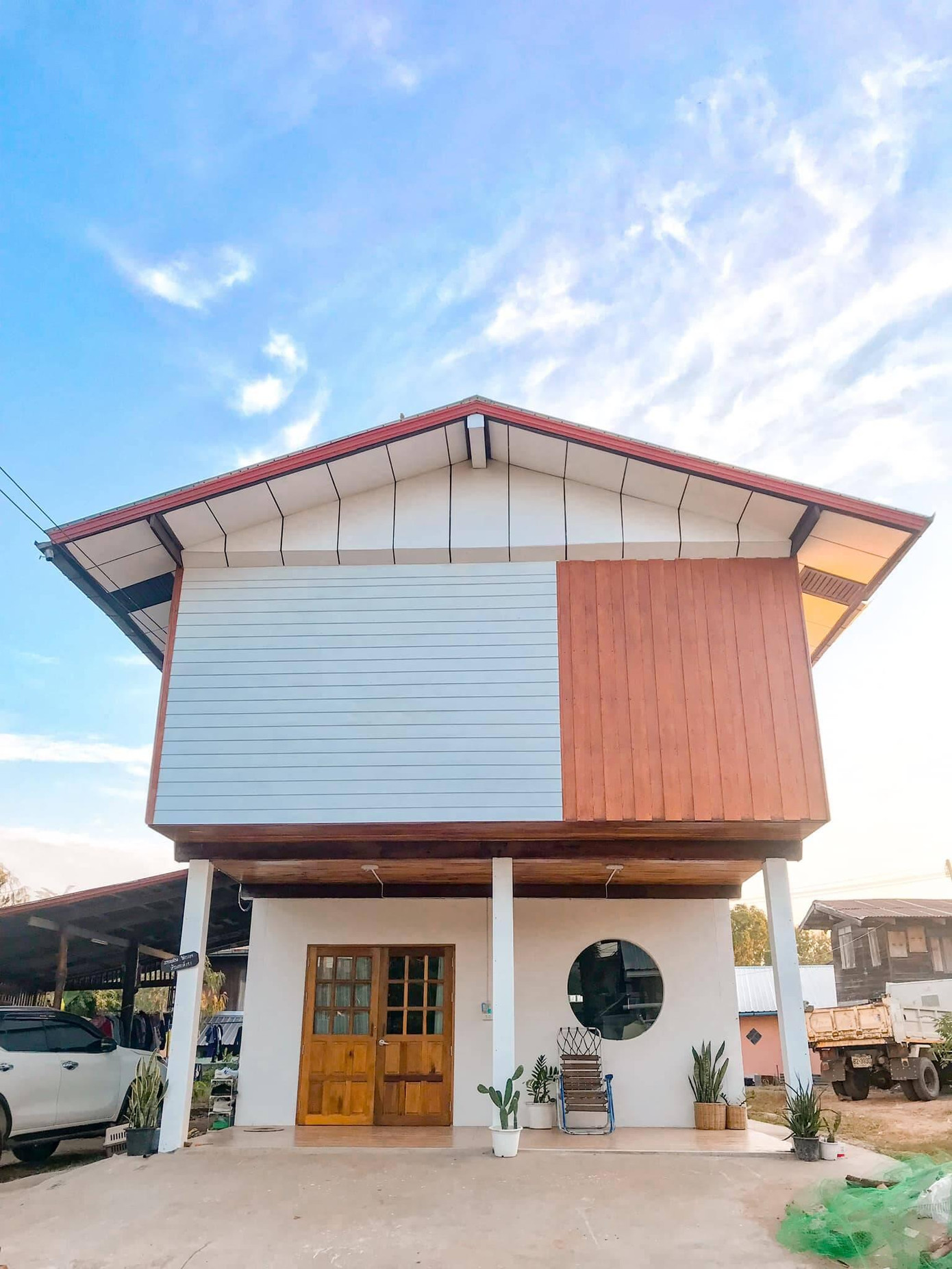 Tầng bên trên sử dụng kết cấu gỗ sẵn có và được sơn sửa lại cho mới. Để ngôi nhà có diện mạo bắt mắt hơn, gia chủ kết hợp tông màu kem và nâu gỗ ở phần mặt tiền.