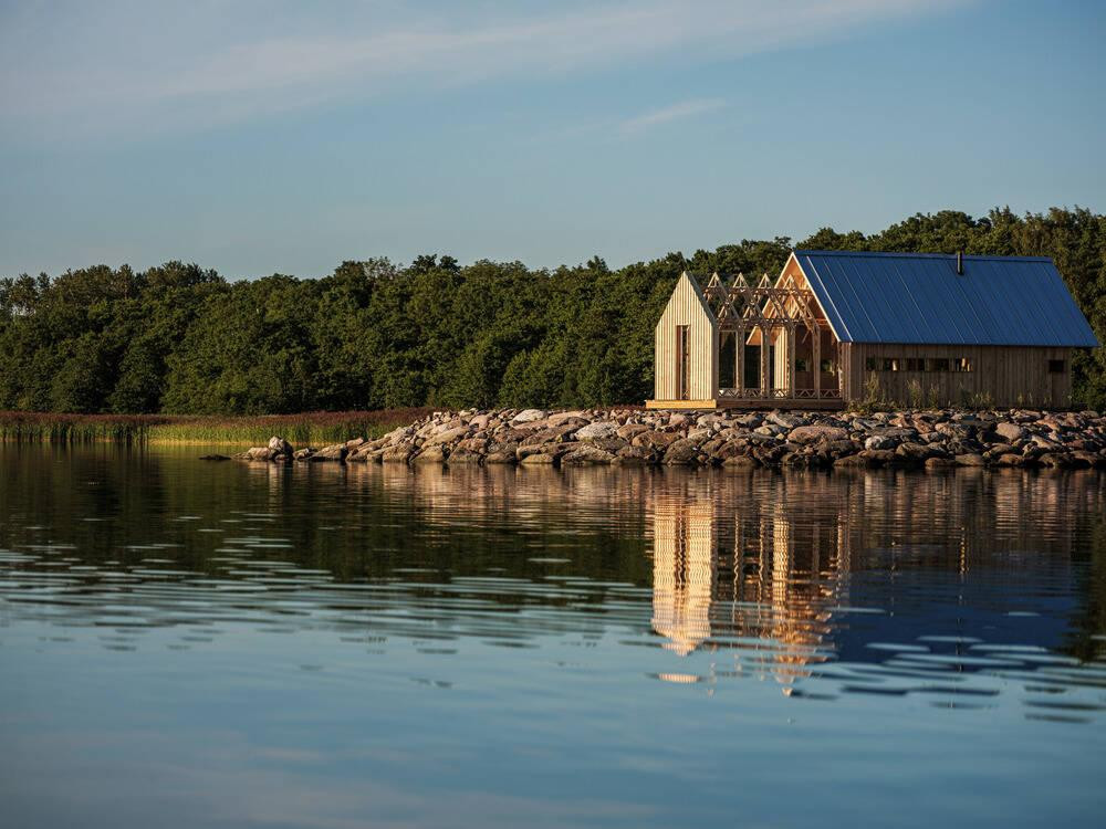 Nhờ cách dịch chuyển khung gỗ vách kính, ngôi nhà có thể tái cấu trúc không gian tùy ý. Không gian bán mở có thể trượt lên trước nhà và trở thành một phòng khách.