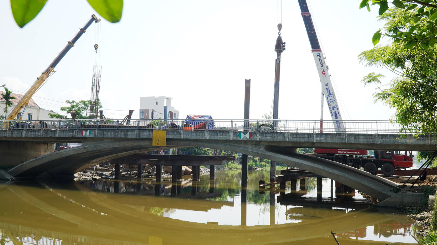 Công trình dang dở, “lọt” giữa sông nhiều năm, theo giải thích của chủ đầu tư là do vướng giải phóng mặt bằng liên quan nhiều nhà dân ở hai đầu cầu, trong khi nguồn vốn xây đường dẫn hai đầu cầu chậm được bố trí...