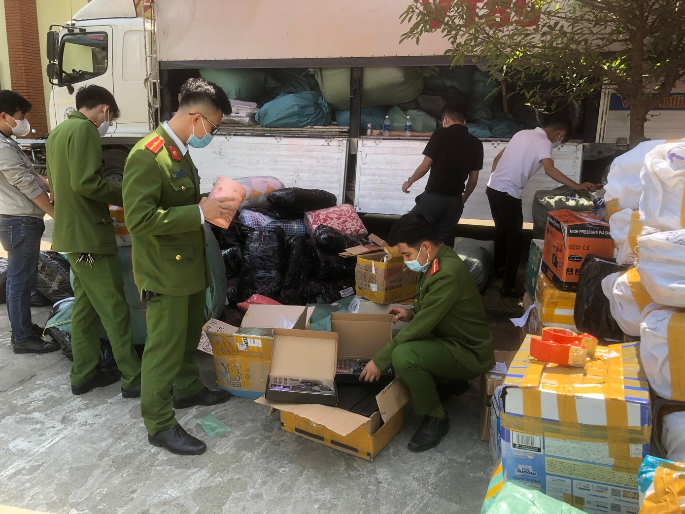 Công an kiểm tra các lô hàng cấm, hàng nhập lậu được bốc dỡ xuống từ xe tải