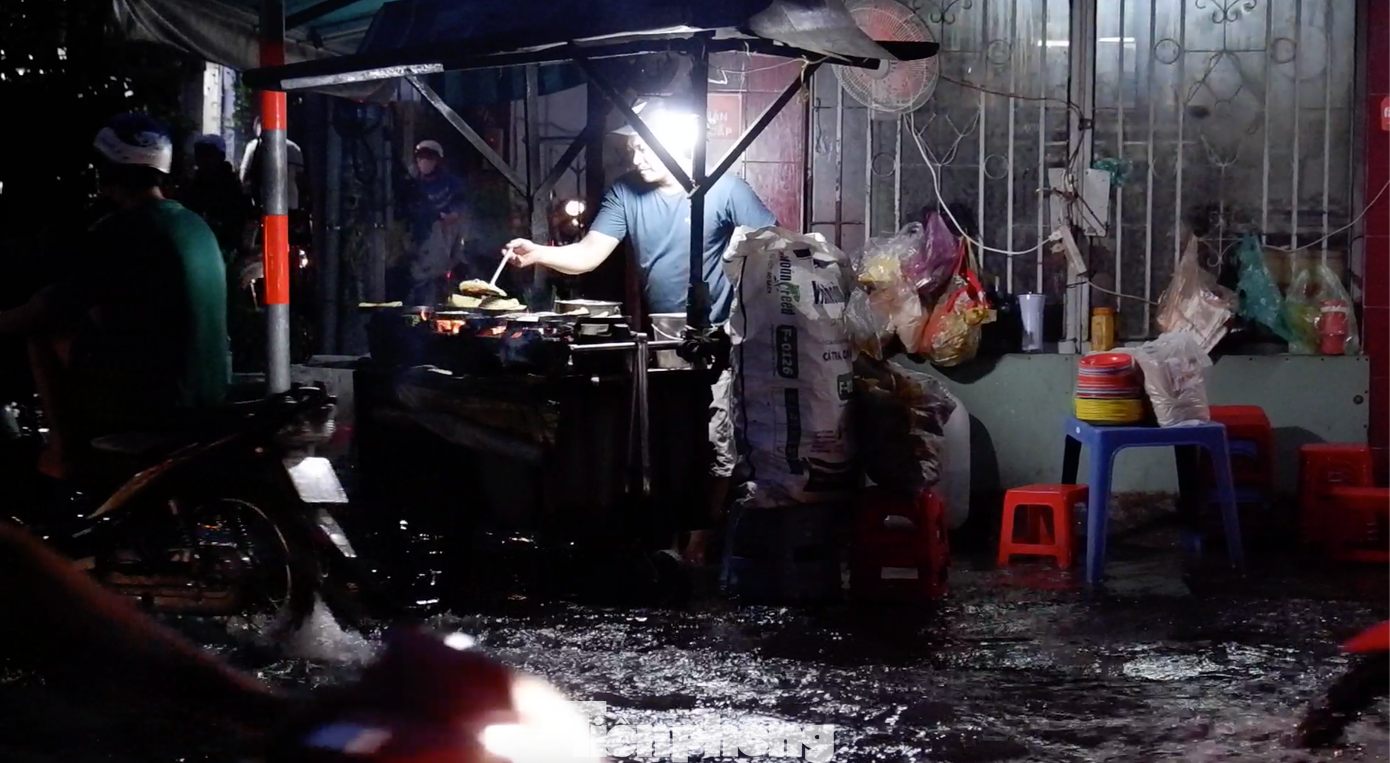 Nhiều hàng quán của người dân trên đường Trần Xuân Soạn phải vừa bán vừa &quot;chạy lụt&quot;.