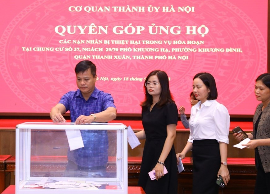 Cán bộ, công chức, viên chức và người lao động cơ quan Thành ủy Hà Nội quyên góp ủng hộ các nạn nhân trong vụ cháy chung cư mini tại quận Thanh Xuân. (Ảnh: Văn Điệp/TTXVN)