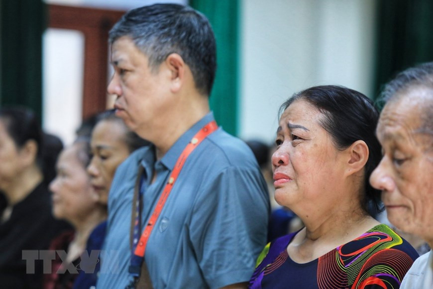 Người dân đau xót trước những mất mát quá lớn do vụ hỏa hoạn gây ra. (Ảnh: Tuấn Anh/TTXVN)