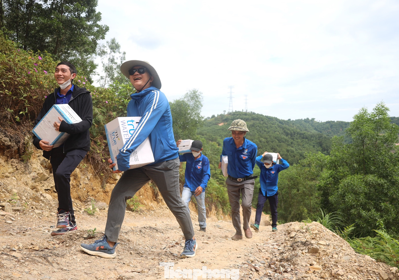 Các đoàn viên thanh niên vượt núi, vận chuyển nước lên tiếp sức cùng lực lượng thi công cột điện tại cột 309 qua xã Khánh Sơn (Nam Đàn, Nghệ An).