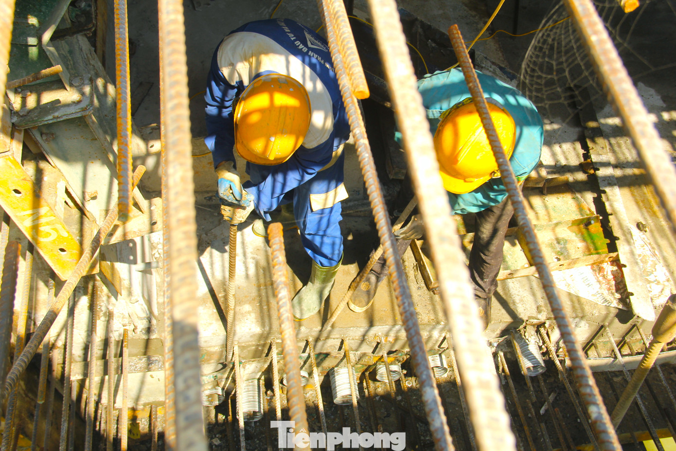 Tại điểm nối giữa các nhịp trên sông, công nhân đang làm những công đoạn cuối cùng để đổ bê tông hợp long cầu trong ít ngày tới.