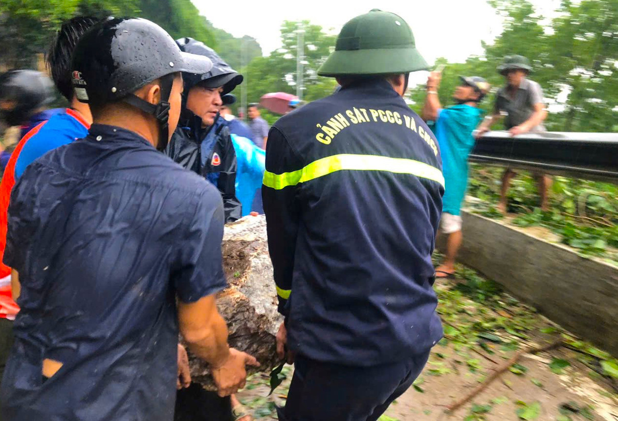 Lực lượng chức năng cắt cành, dọn hiện trường, đưa chiếc xe máy gặp nạn ra ngoài. Ảnh: Bá Hậu Lực lượng chức năng cắt cành, dọn hiện trường, đưa chiếc xe máy gặp nạn ra ngoài. Ảnh: Bá Hậu