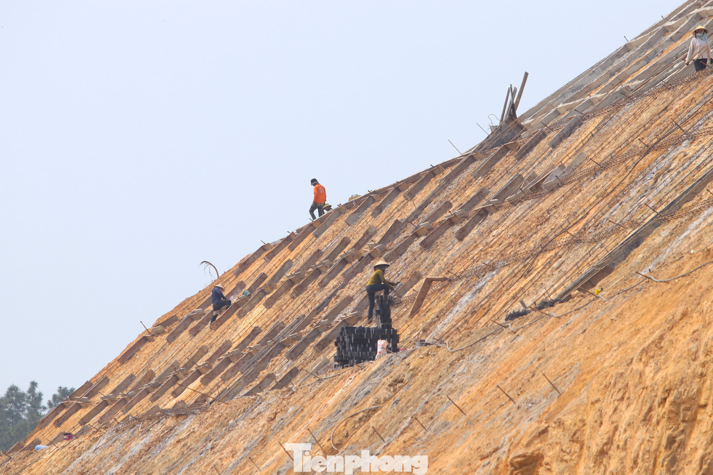 Trên mái núi xung quanh hầm đang được các công nhân đổ bê tông theo thiết kế để chống sạt lở. Trên mái núi xung quanh hầm đang được các công nhân đổ bê tông theo thiết kế để chống sạt lở.