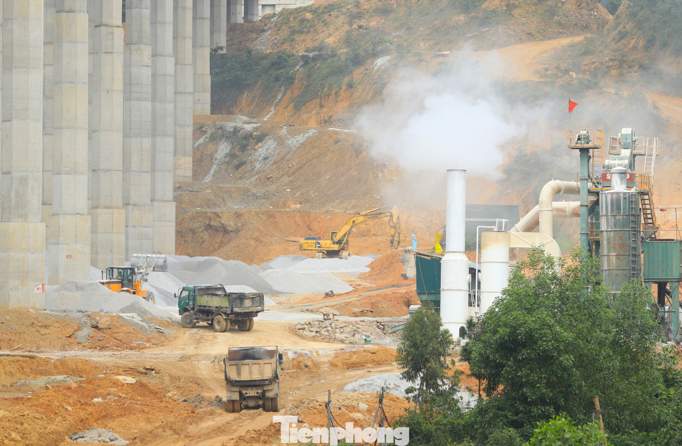 Những chiếc máy xúc, xe tải vẫn nhộn nhịp ra vào các trạm trộn bê tông nhựa trên công trường để lấy vật liệu làm việc ngày cuối cùng của năm.