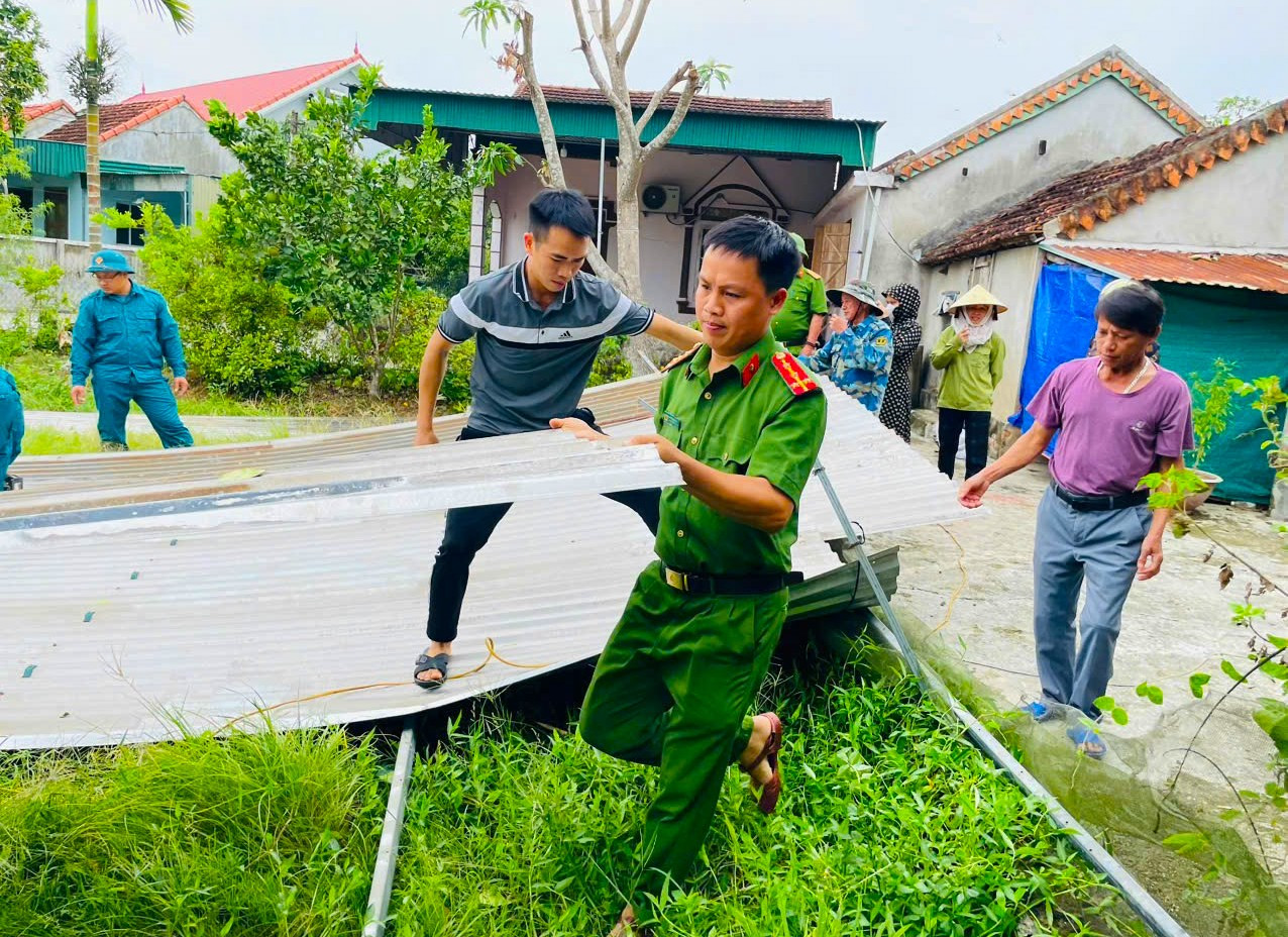 Đoàn viên thanh niên huyện Quỳ Châu (Nghệ An) phối hợp lực lượng công an huyện đến hỗ trợ các gia đình bị mưa gió làm tốc mái tôn.