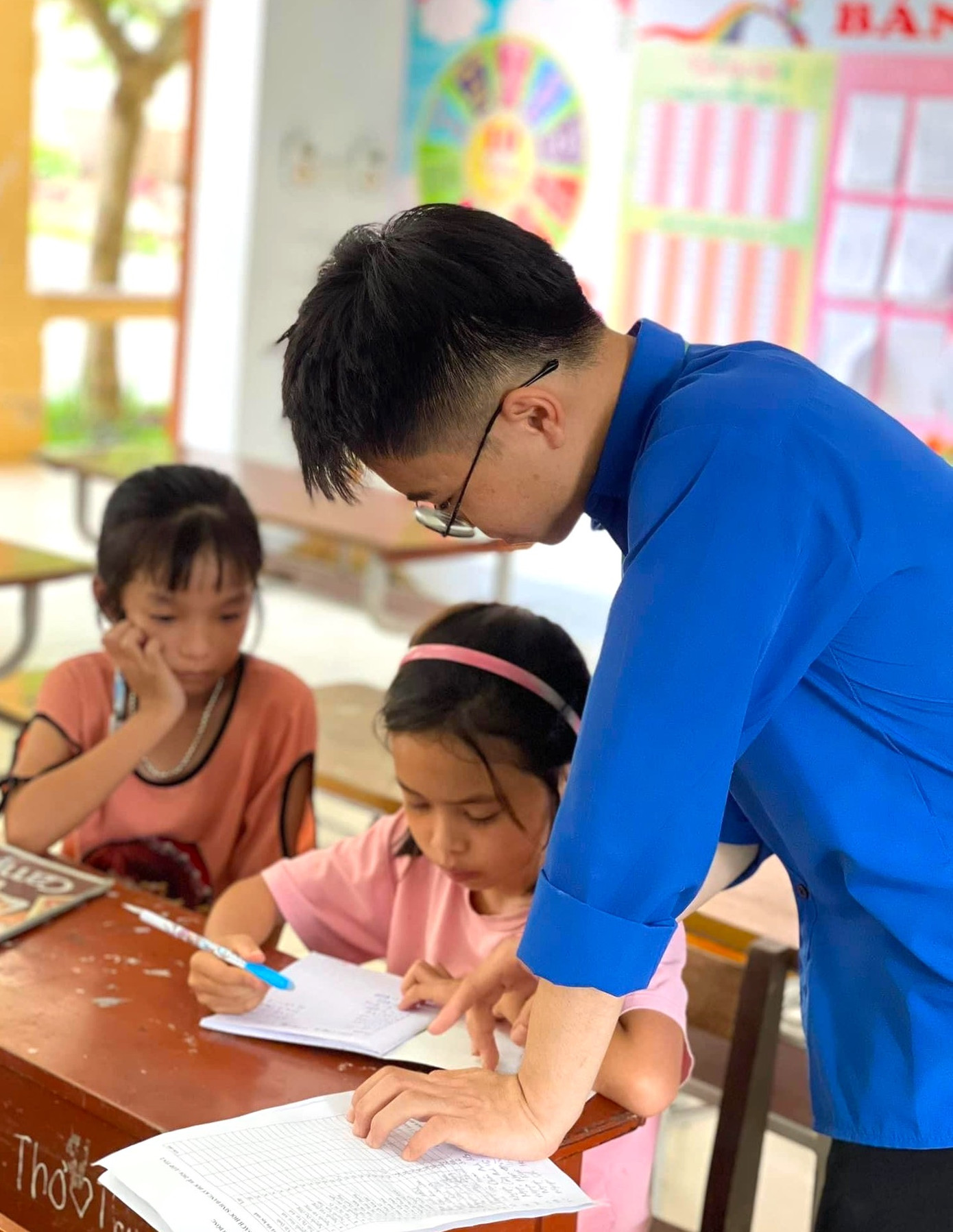 Các đoàn viên thanh niên tận tình dạy bảo các em nhỏ.