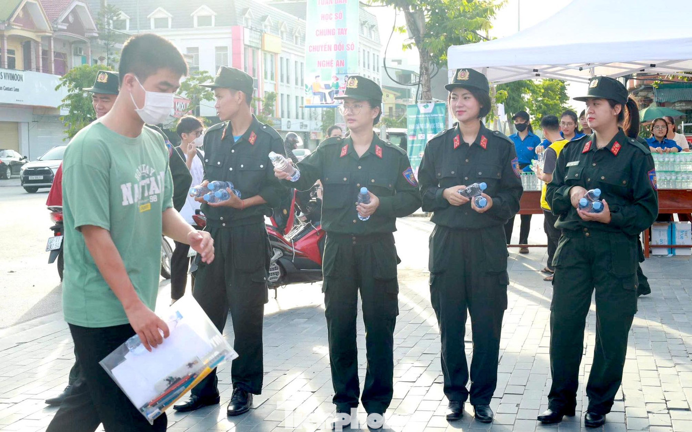 Các chiến sĩ Ban Thanh niên Công an tỉnh Nghệ An phát nước tiếp sức sĩ tử tại điểm thi trường THPT Huỳnh Thúc Kháng.